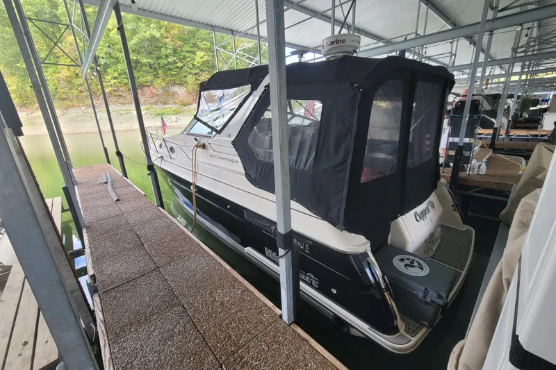 Slide: The Image of 1998 Wellcraft 3200 Martinique boat docked under a covered marina. - 5