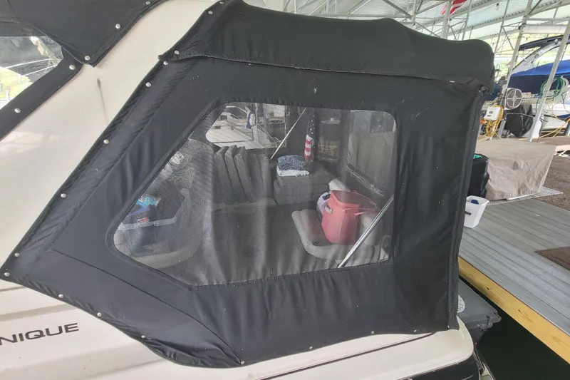 Slide: The Image of 1998 Wellcraft 3200 Martinique boat with black canvas cover in a marina. - 6