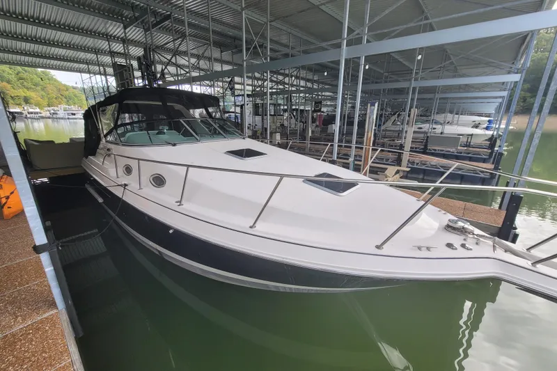 Slide: The Image of 1998 Wellcraft 3200 Martinique docked in a covered marina. - 7