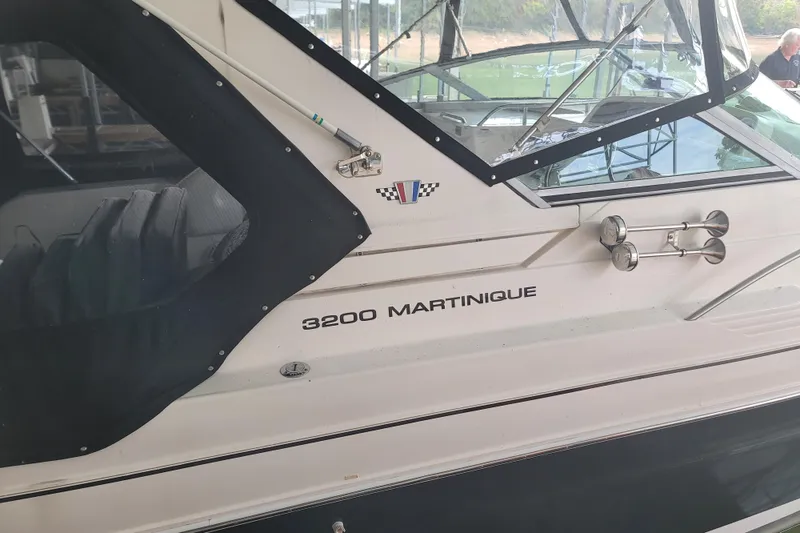 Slide: The Image of 1998 Wellcraft 3200 Martinique boat with canopy, docked in a marina. - 8