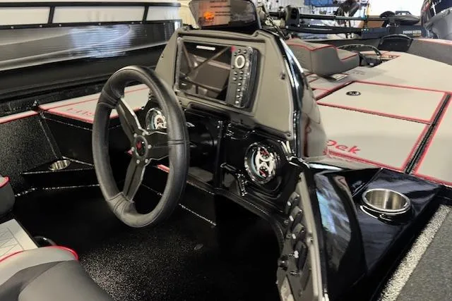 Slide: The Image of 2026 Xpress H18 Bass boat interior with steering wheel and control panel. - 12