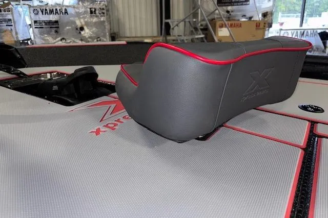 Slide: The Image of 2026 Xpress H18 Bass boat interior with gray and red seating. - 14