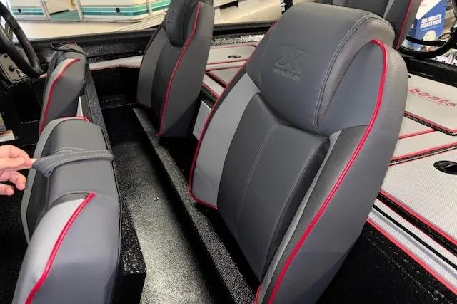 Slide: The Image of 2026 Xpress H18 Bass boat interior with gray and red seats. - 15