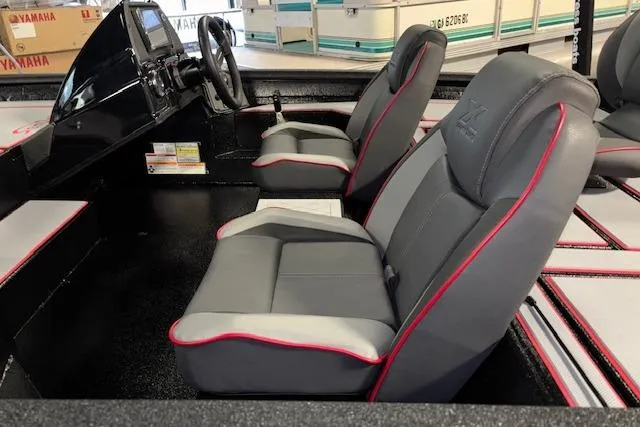 Slide: The Image of 2026 Xpress H18 Bass boat interior with gray and red-trimmed seats. - 17
