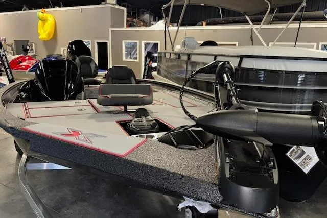 Slide: The Image of 2026 Xpress H18 Bass boat in showroom, featuring modern design and equipment. - 21