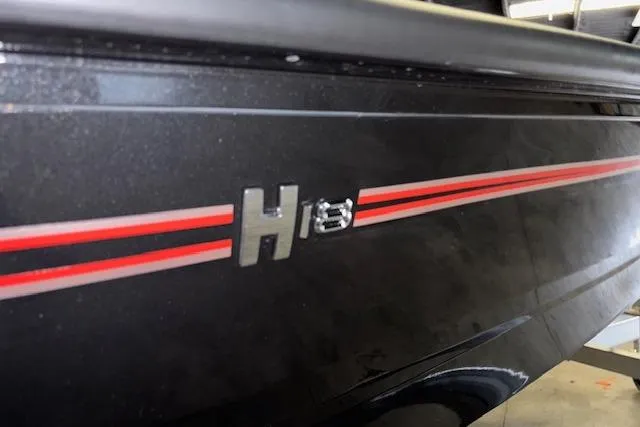 Slide: The Image of 2026 Xpress H18 Bass boat with red stripe detail on black hull. - 30