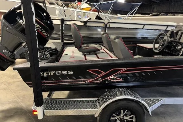 Slide: The Image of 2026 Xpress H18 Bass boat with Yamaha engine on a trailer in a showroom. - 31