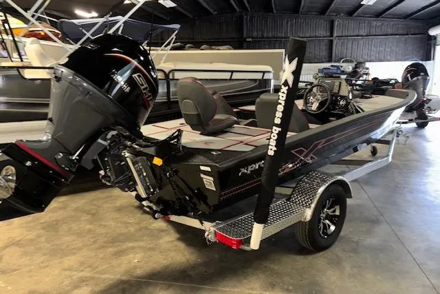 Slide: The Image of 2026 Xpress H18 Bass boat in showroom, featuring sleek design and powerful engine. - 4