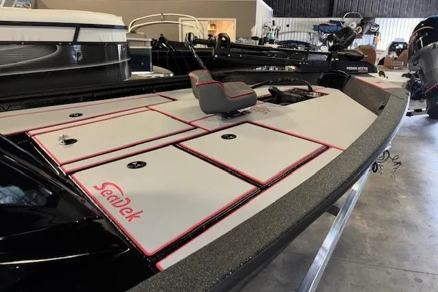 Slide: The Image of 2026 Xpress H18 Bass boat with SeaDek flooring in a showroom. - 5