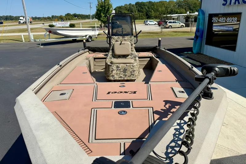 Slide: The Image of 2019 Excel 230 Bay Pro boat with camouflage seating and spacious deck. - 10