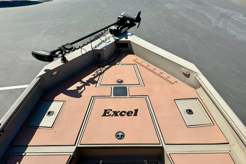 Slide: The Image of 2019 Excel 230 Bay Pro boat deck with storage compartments and trolling motor. - 11