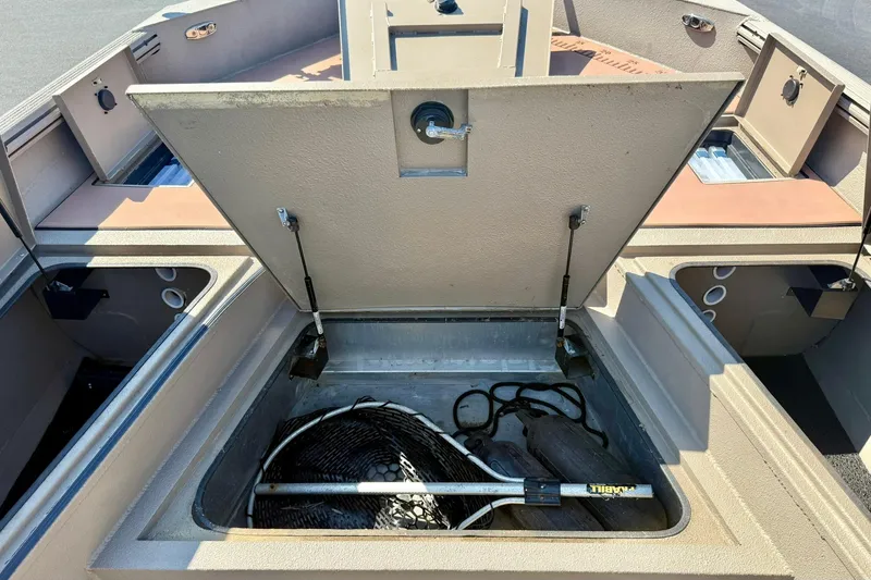 Slide: The Image of 2019 Excel 230 Bay Pro boat storage compartment with fishing gear and equipment. - 16