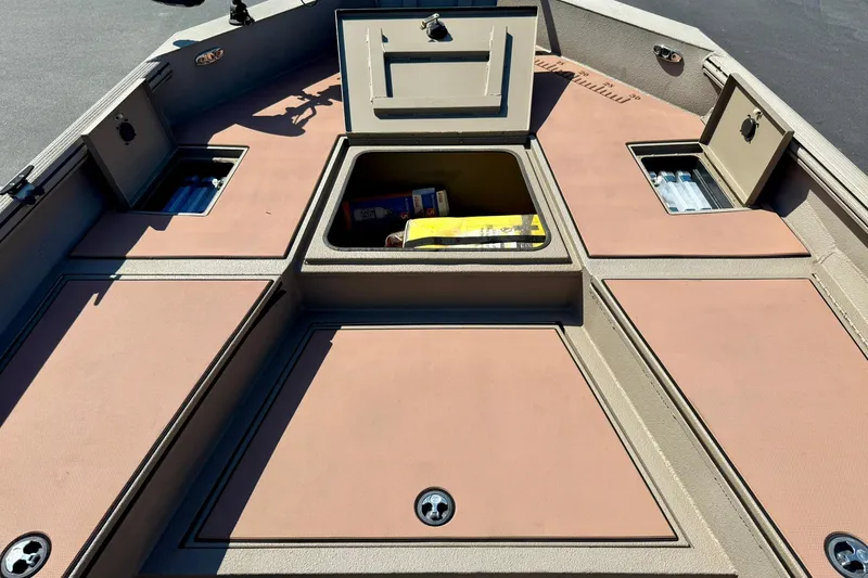 Slide: The Image of 2019 Excel 230 Bay Pro boat deck with open storage compartments. - 17