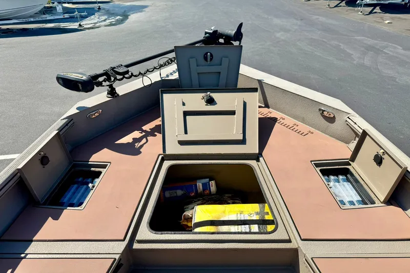 Slide: The Image of 2019 Excel 230 Bay Pro boat deck with storage compartments open, showcasing interior features. - 18