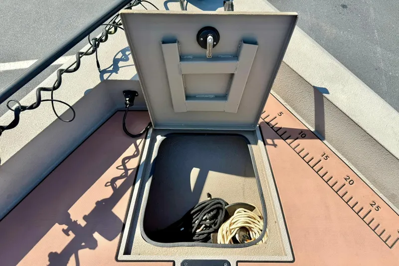 Slide: The Image of Open storage compartment on 2019 Excel 230 Bay Pro boat with ropes inside. - 19