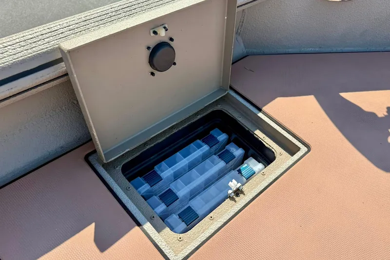 Slide: The Image of Open storage compartment on 2019 Excel 230 Bay Pro boat deck. - 21