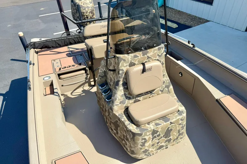 Slide: The Image of 2019 Excel 230 Bay Pro boat interior with camouflage seating and console. - 23