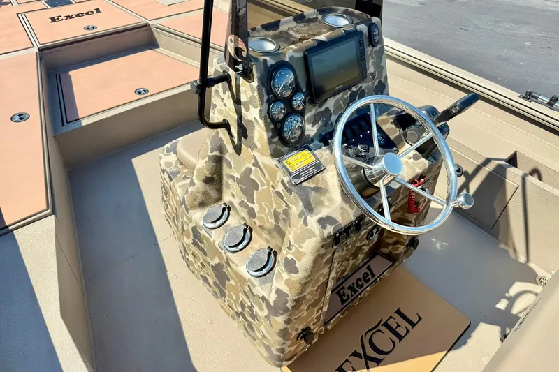 Slide: The Image of 2019 Excel 230 Bay Pro boat console with camouflage design and steering wheel. - 26