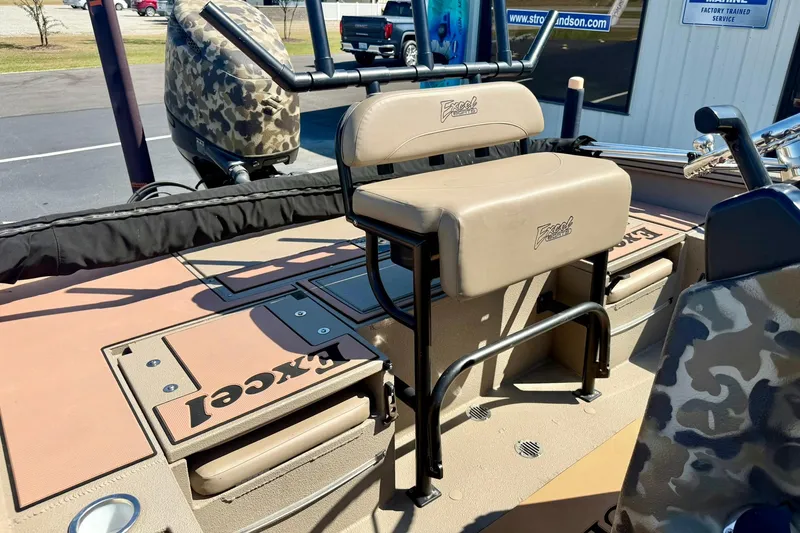 Slide: The Image of 2019 Excel 230 Bay Pro boat interior with seating and camouflage design. - 29