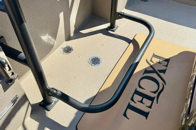 Slide: The Image of 2019 Excel 230 Bay Pro boat deck with logo and metal railing. - 30