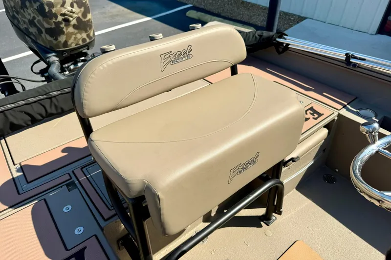 Slide: The Image of 2019 Excel 230 Bay Pro boat seat with beige upholstery and logo detail. - 31