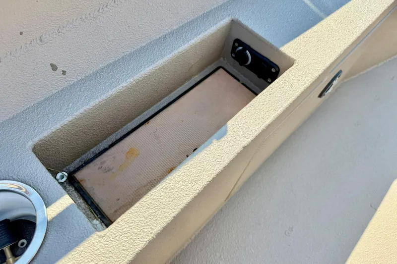 Slide: The Image of 2019 Excel 230 Bay Pro boat storage compartment with textured surface and control panel. - 33