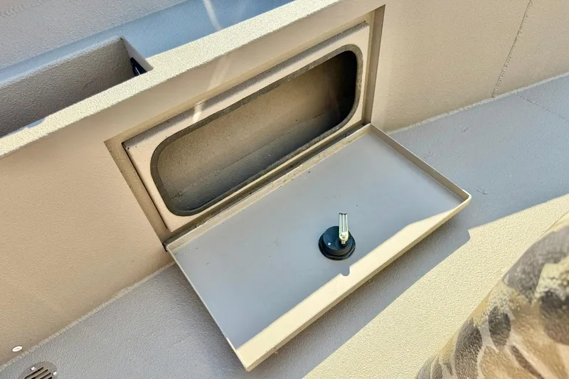 Slide: The Image of 2019 Excel 230 Bay Pro boat storage compartment with latch, open and empty. - 34
