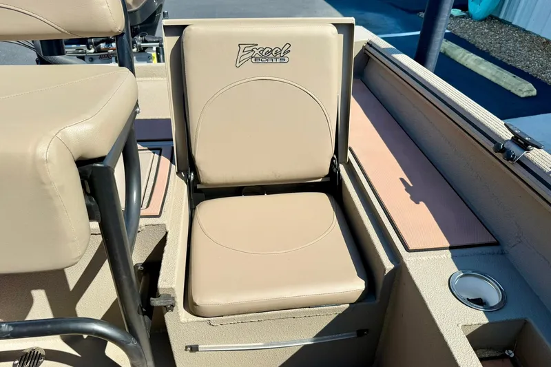 Slide: The Image of 2019 Excel 230 Bay Pro boat seat with beige upholstery and cup holder. - 42