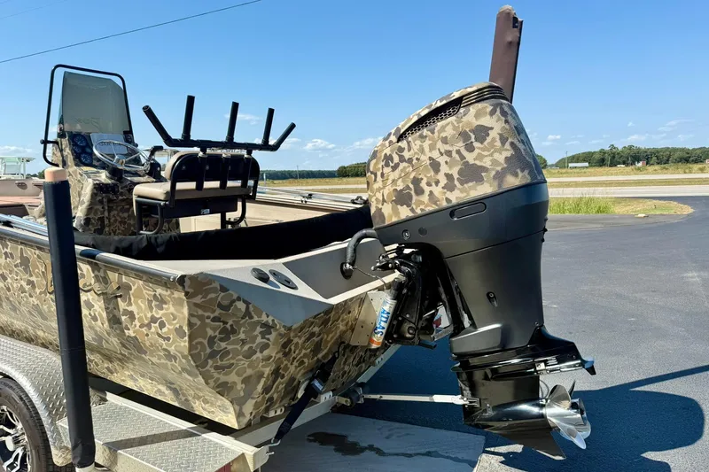 Slide: The Image of 2019 Excel 230 Bay Pro boat with camouflage design and powerful outboard motor. - 46