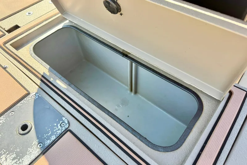 Slide: The Image of Open storage compartment on a 2019 Excel 230 Bay Pro boat deck. - 48