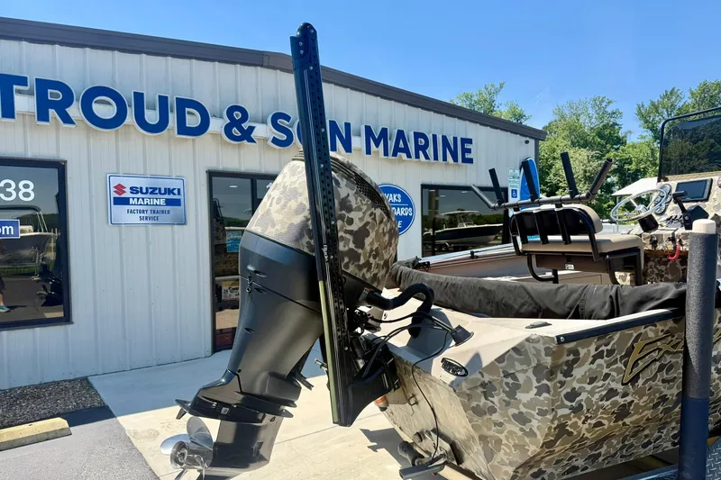 Slide: The Image of 2019 Excel 230 Bay Pro boat with camouflage design at marine dealership. - 49