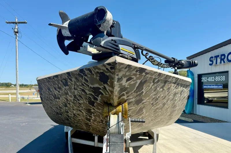 Slide: The Image of 2019 Excel 230 Bay Pro boat with camouflage design on a trailer. - 8