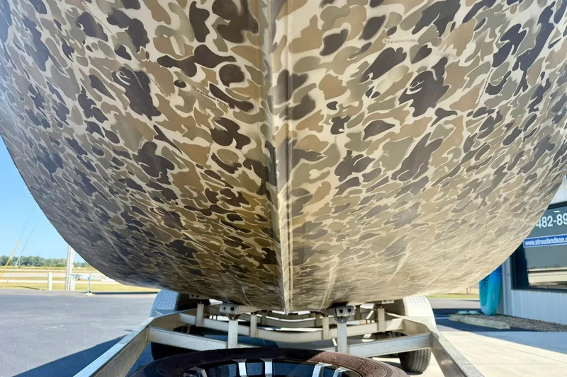 Slide: The Image of 2019 Excel 230 Bay Pro boat with camouflage pattern on trailer. - 9