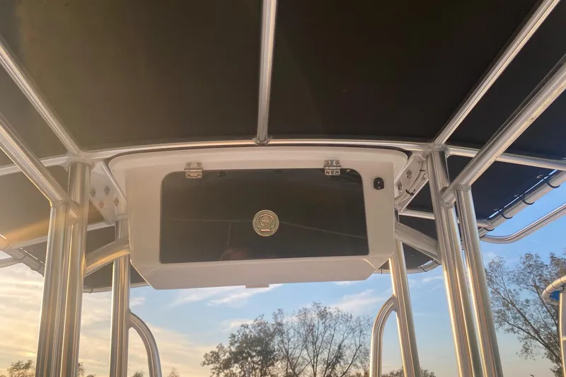 Slide: The Image of 1997 Hydra-Sports 1800 CC boat canopy with storage compartment, under a clear sky. - 8