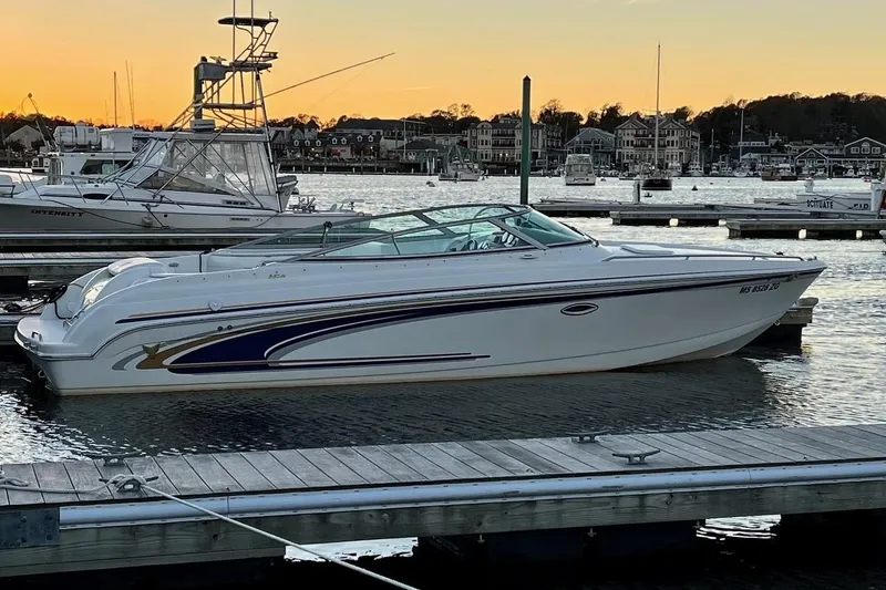 Slide: The Image of 2002 Formula 260 Sun Sport boat docked at sunset in a marina. - 0