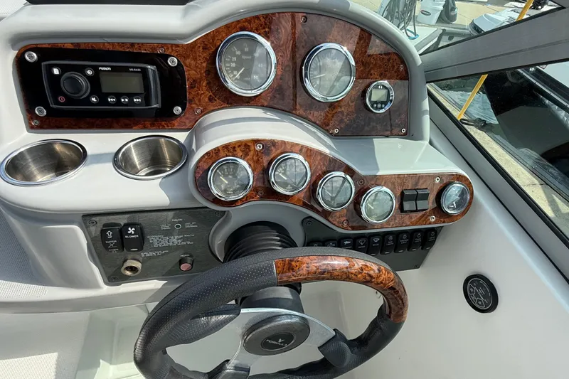 Slide: The Image of 2002 Formula 260 Sun Sport dashboard with wood accents and steering wheel. - 11