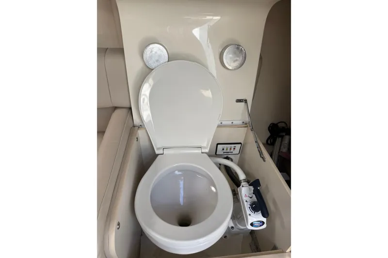 Slide: The Image of Boat toilet in a 2002 Formula 260 Sun Sport, featuring a manual flush system. - 16