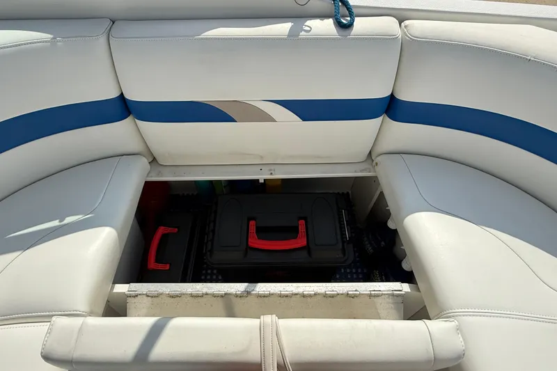 Slide: The Image of 2002 Formula 260 Sun Sport boat interior storage compartment with white and blue seating. - 18