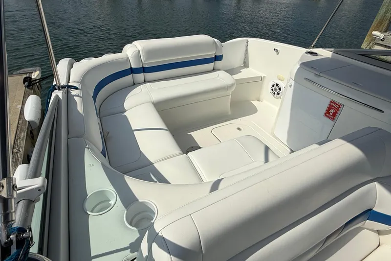 Slide: The Image of 2002 Formula 260 Sun Sport boat interior with white seating and blue accents. - 19