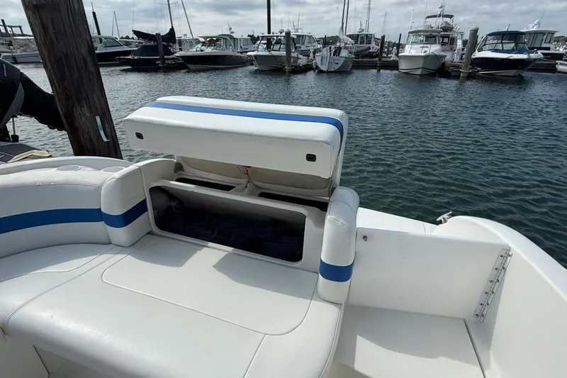 Slide: The Image of 2002 Formula 260 Sun Sport boat with open storage compartment at marina. - 21