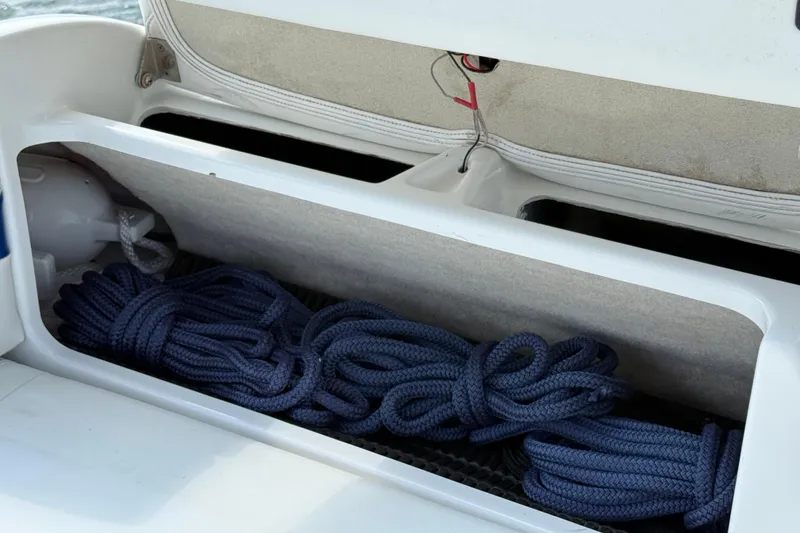 Slide: The Image of Storage compartment with blue ropes on a 2002 Formula 260 Sun Sport boat. - 23