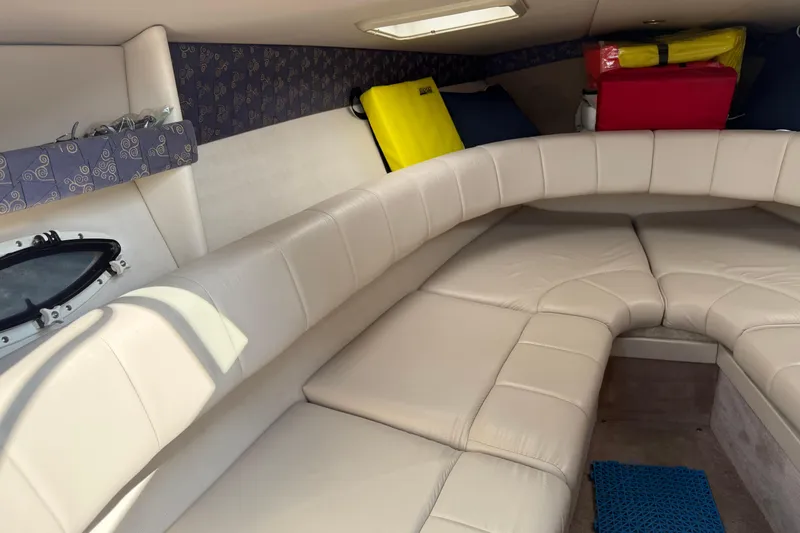 Slide: The Image of 2002 Formula 260 Sun Sport cabin with beige seating and storage compartments. - 24