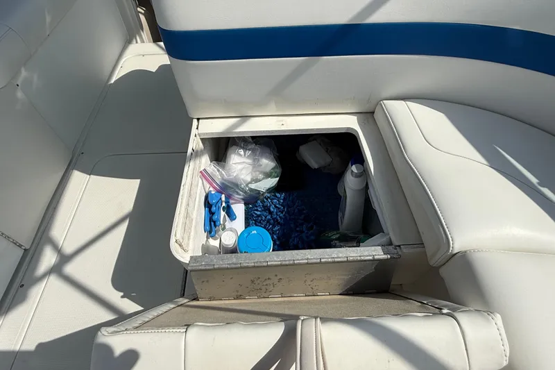 Slide: The Image of Storage compartment on a 2002 Formula 260 Sun Sport boat with various items inside. - 25