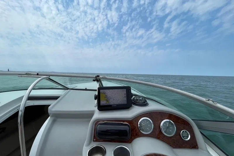 Slide: The Image of Cockpit view of 2002 Formula 260 Sun Sport boat on open water under blue sky. - 28