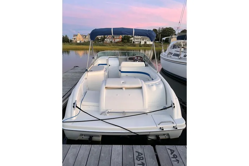 Slide: The Image of 2002 Formula 260 Sun Sport boat docked at sunset with blue canopy. - 5