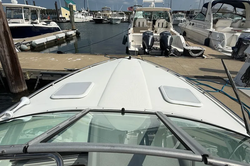 Slide: The Image of 2002 Formula 260 Sun Sport boat docked at marina with other vessels. - 6