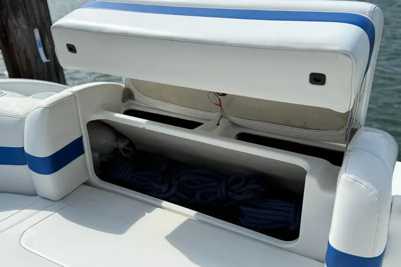 Slide: The Image of 2002 Formula 260 Sun Sport boat storage compartment with blue ropes inside. - 8
