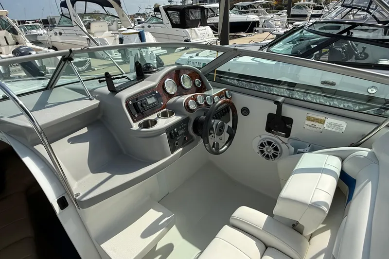 Slide: The Image of 2002 Formula 260 Sun Sport boat cockpit with steering wheel and control panel. - 9