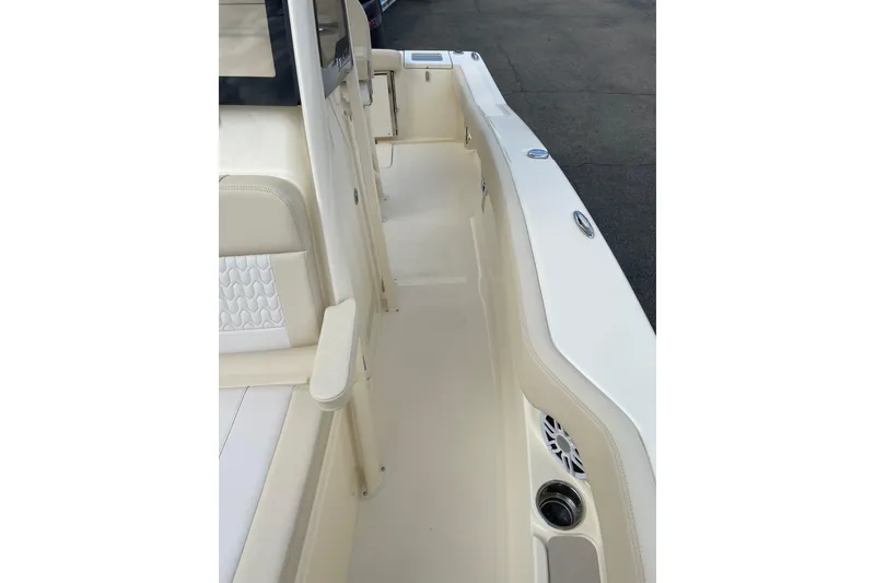 Slide: The Image of 2026 Scout 215 XSF boat interior with beige seating and sleek design. - 10
