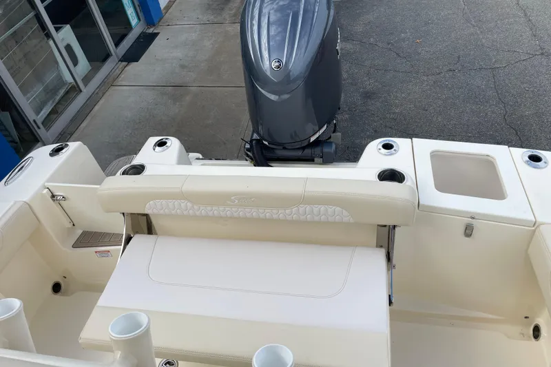 Slide: The Image of 2026 Scout 215 XSF boat interior with seating and outboard motor. - 15
